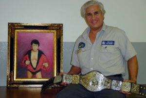 pic of the wrestler with portrait and belt unfolded