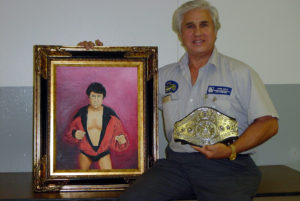 pic of the wrestler with portrait and belt